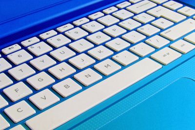 An image of a computer keyboard on blue background.