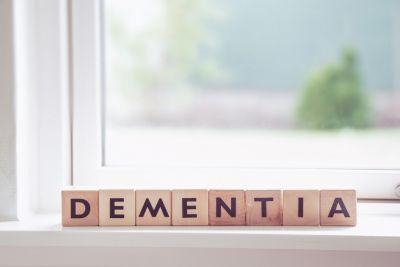 Image of the word dementia spelled out by wooden blocks with letters on them. The blocks are positioned on a window sill.