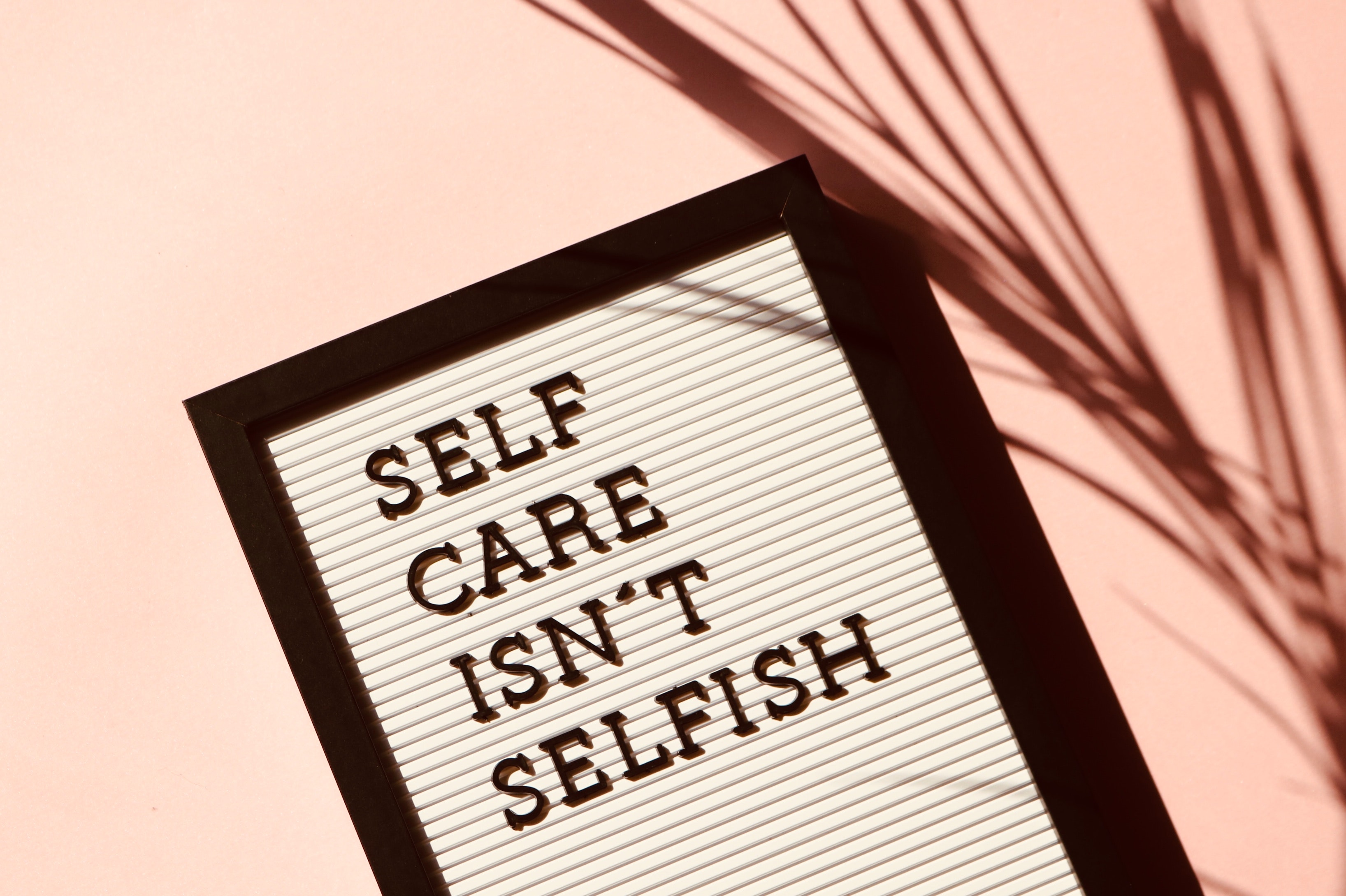 Words say "self care isn't selfish"